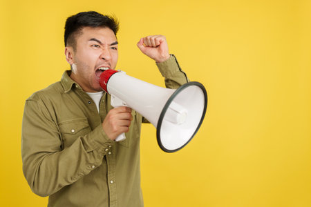 Upset chinese man shouting using a loudspeakerの写真素材