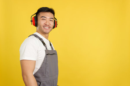Chinese carpenter with protective gear smiling at the cameraの写真素材