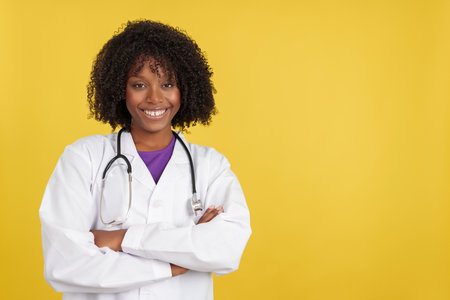 Female doctor with afro hair smiling at cameraの写真素材