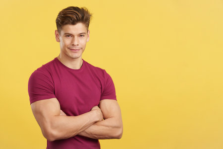 Strong man smiling at the camera with arms crossedの写真素材