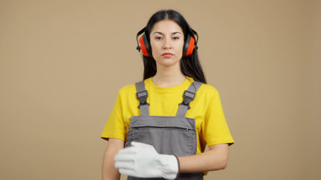 Serious female worker standing with arms crossed looking at cameraの写真素材