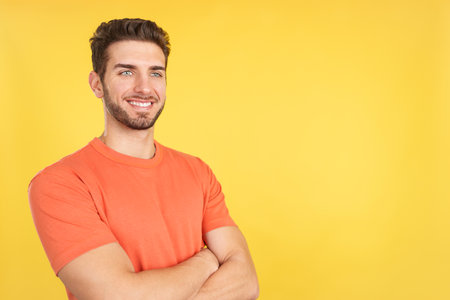 Happy caucasian man standing with arms crossedの写真素材