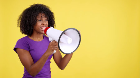 African woman yelling while using a mefaphoneの写真素材