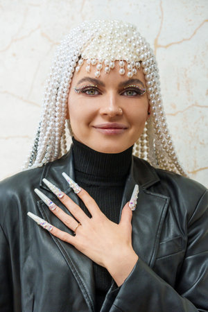 Female artist showing a hand with decorated fake nailsの写真素材