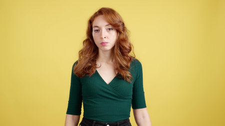 Redheaded woman looking at camera with an angry expressionの写真素材