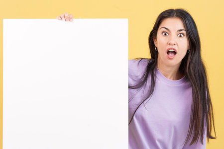 Surprised caucasian woman hair holding a blank panelの写真素材
