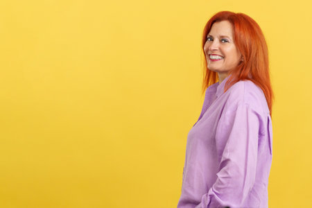 Happy redheaded mature woman smiling at the cameraの写真素材