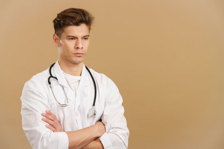 Serious doctor with arms crossed looking awayの写真素材