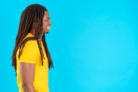 Profile of a latin man with dreadlocks looking ahead