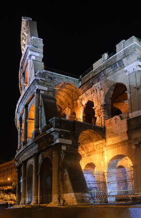Vertical view of Colosseum in Rome illuminated at nightの写真素材