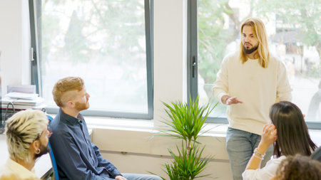 Young man talking during a business meeting in a coworking