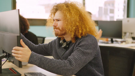 Angry worker experiencing computer problems in a coworking