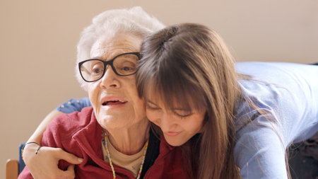 Granddaughter embracing her grandmother in a geriatric