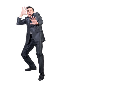 Terrified man in light studio. White background.の写真素材