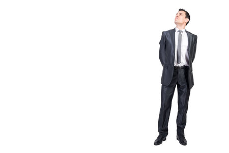 Optimistic businessman in suit in studio. White background.の写真素材