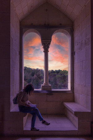 Woman reading at sunset inside the Alcazarの写真素材