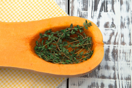 pumpkin and thyme on a white wooden backgroundの写真素材