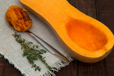 pumpkin and thyme on a dark wooden backgroundの写真素材