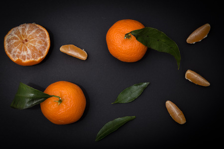 Ripe mandarin citrus on black backgroundの写真素材
