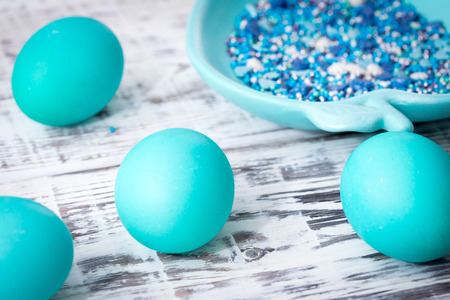 Easter eggs and decor on light background