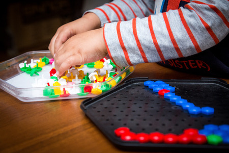 the child puts a multicolored mosaic.の写真素材