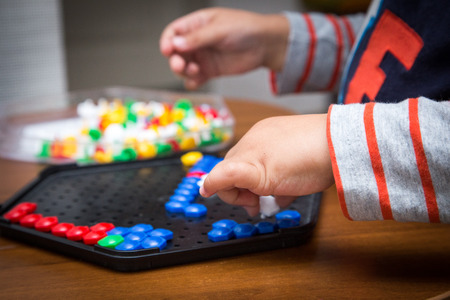 the child puts a multicolored mosaic.の写真素材