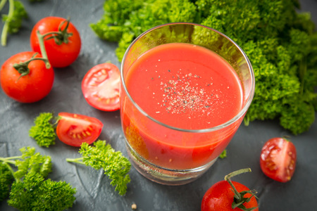 fresh organic tomatoes and tomato juice with parsley. the detox conceptの写真素材