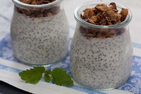 chia seed pudding with granola in a glass jar.の写真素材