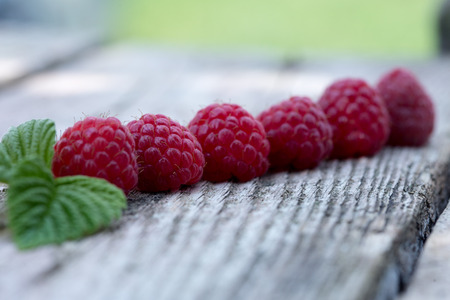 fresh organic berries. raspberries on old wooden table.