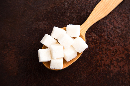 white Sugar cubes on the wooden spoon.の写真素材
