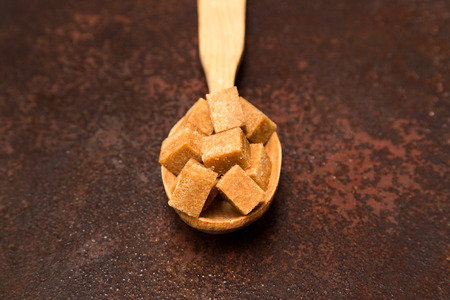 brown Sugar cubes on the wooden spoon.の写真素材