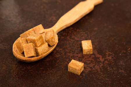 brown Sugar cubes on the wooden spoon.の写真素材