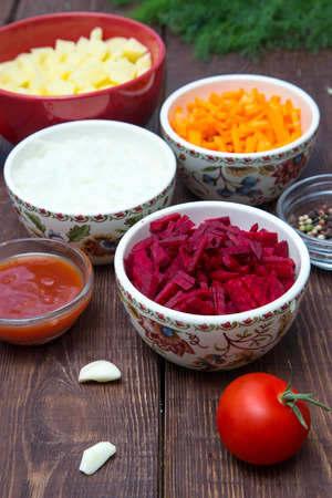 Ingredients for borscht, beetroot soup, beet soup: carrots, onions, garlic, beets, tomatoes, potatoes. Harvest vegetables. The concept of vegetarianism, vegan, healthy eating.の写真素材
