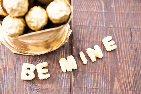 gold bag of chocolates. candy in Golden foil with copy space.の写真素材