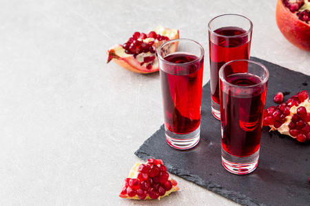 Pomegranate liqueur, Pomegranate juice. old wooden background, selective focus.の写真素材