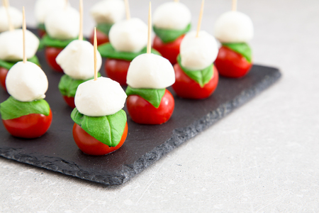 Caprese salad. Skewers with tomato and mozzarella with basilの写真素材