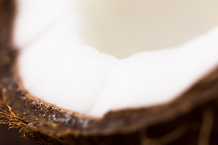 Half of ripe coconut on wooden background.の写真素材