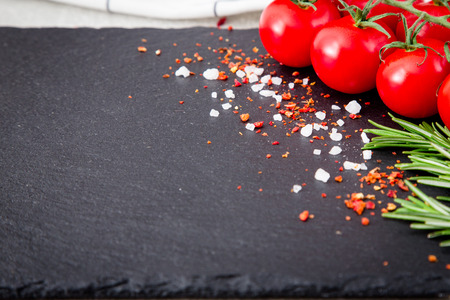 fresh cherry tomatoes with herbs and spices. selective focus, copy spaceの写真素材
