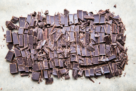 Stack of chocolate slices with mint leaf. dark chocolate over wooden background, selective focus.
