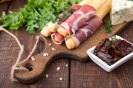 Appetizer with  prosciutto, ham, blue cheese and sun dried tomatoes for holidays .の写真素材