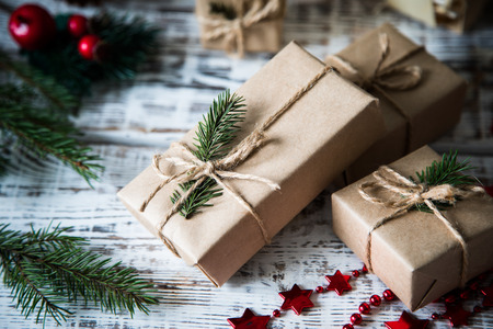 Christmas background. Christmas composition. Christmas gift, pine cones, fir branches on wooden white backgroundの写真素材