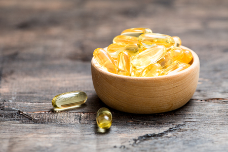 Fish oil capsules with omega 3 and vitamin D. healthy diet conceptの写真素材