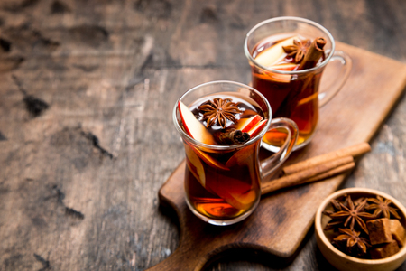 hot spicy beverage. Hot drink (apple tea, punch) with cinnamon stick and star anise. Seasonal mulled drink.の写真素材