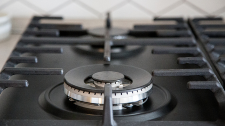 Gas burner on black modern kitchen stove. kitchen gas cooker with burning fire propane gasの写真素材