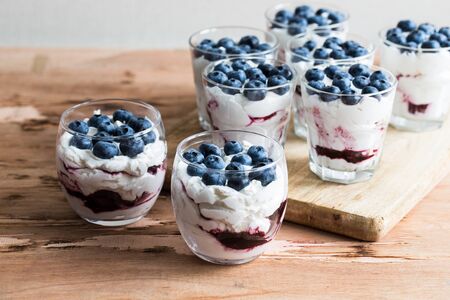 homemade dessert with Greek yoghurt and cream, blueberry jam and fresh blueberry berries.の写真素材