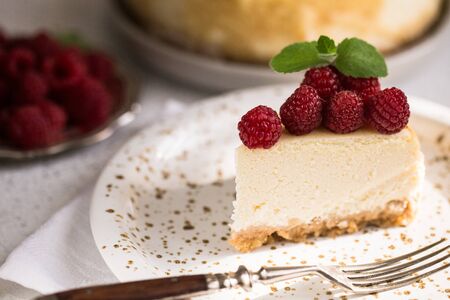 Slice Of Classical New York Cheesecake with raspberries On White Plate. Closeup View. Home bakery concept/の写真素材