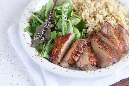 healthy lunch. Serving Couscous with Salad and Roasted Duck Breasts/の写真素材