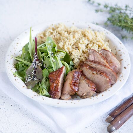 healthy lunch. Serving Couscous with Salad and Roasted Duck Breasts/の写真素材