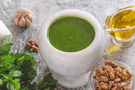Homemade parsley pesto sauce and ingredients. Vegan healthy foodの写真素材
