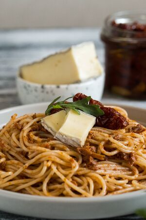 Italian Pasta with sun-dried tomato pesto and brie cheeseの写真素材